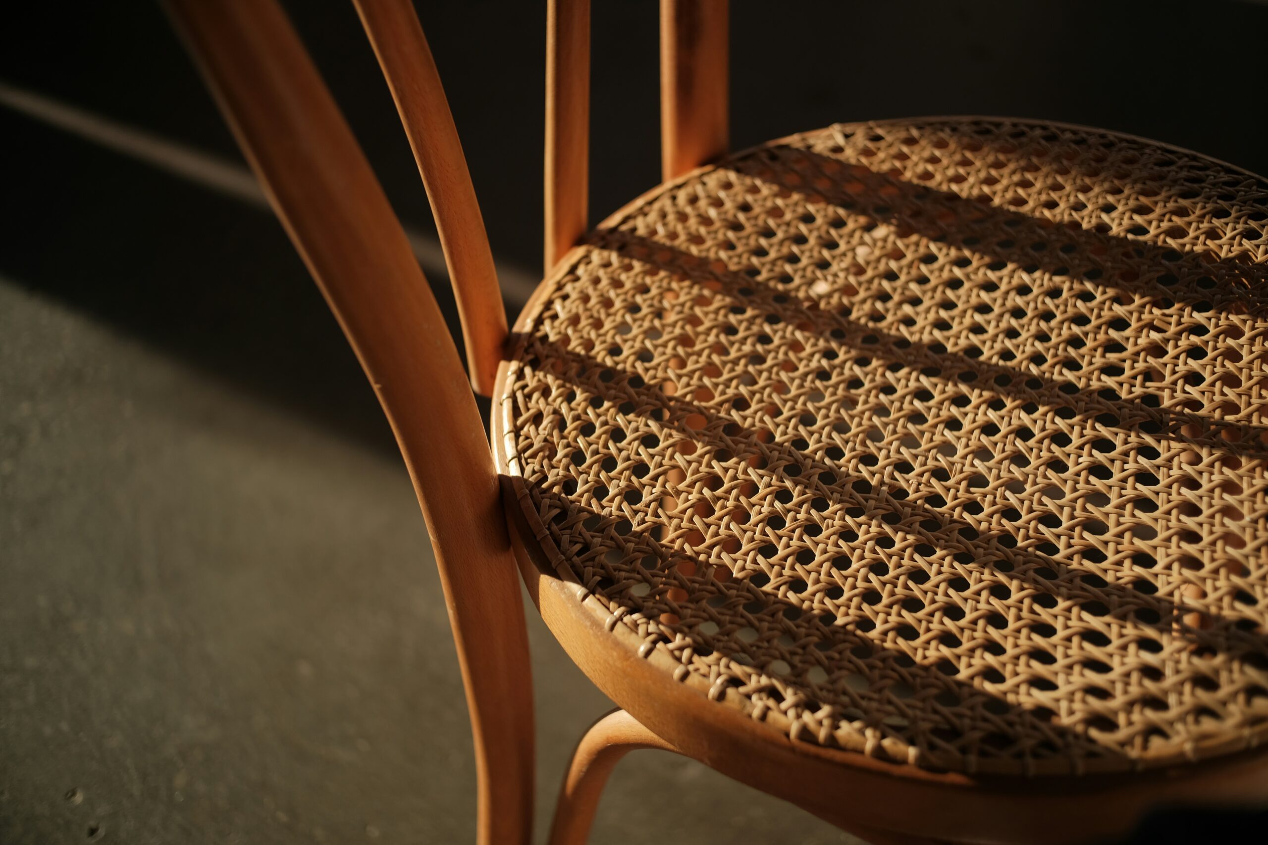 How to tell if rattan furniture is real: close-up of a woven cane chair seat